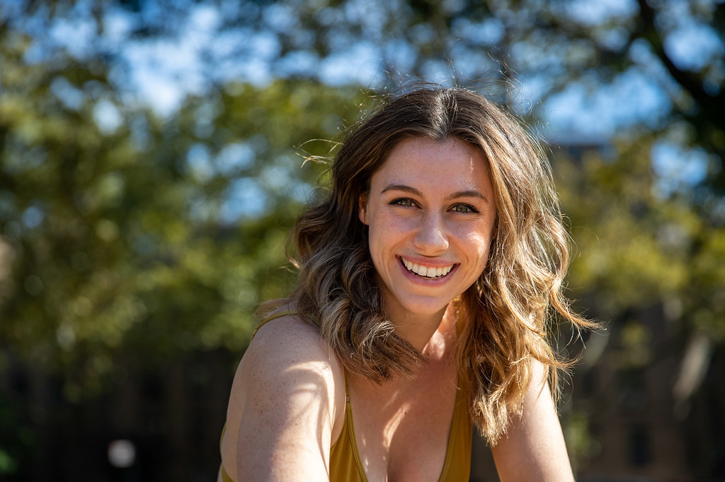 a female with wavy hair smiling at the camera