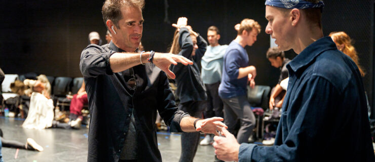 two men gesturing while standing on stage